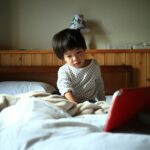 child watching news screen