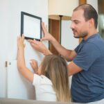 parent helping child with homework on laptop