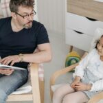 parent reading news on tablet in bright room