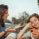 Parent and teen talking computer