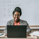 teacher using laptop in classroom