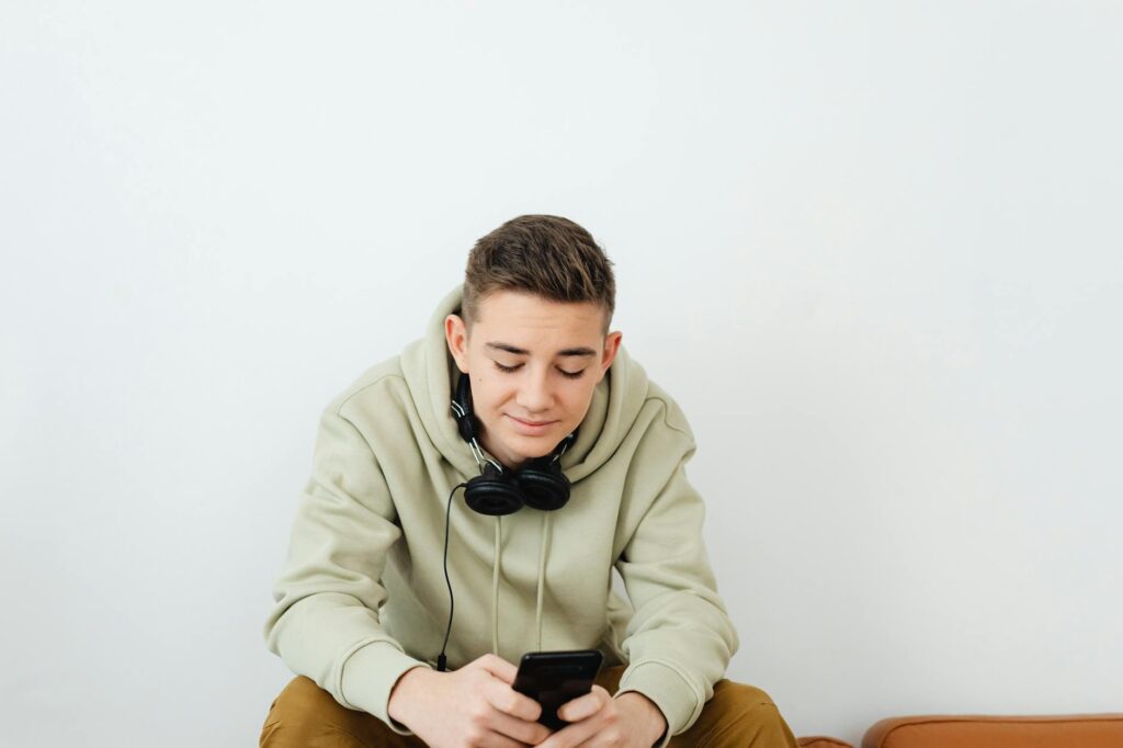 teenager using smartphone on couch