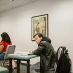 student looking at phone confused